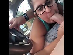 Dark haired female with glasses is fellating penis in the camper, in the middle of the day